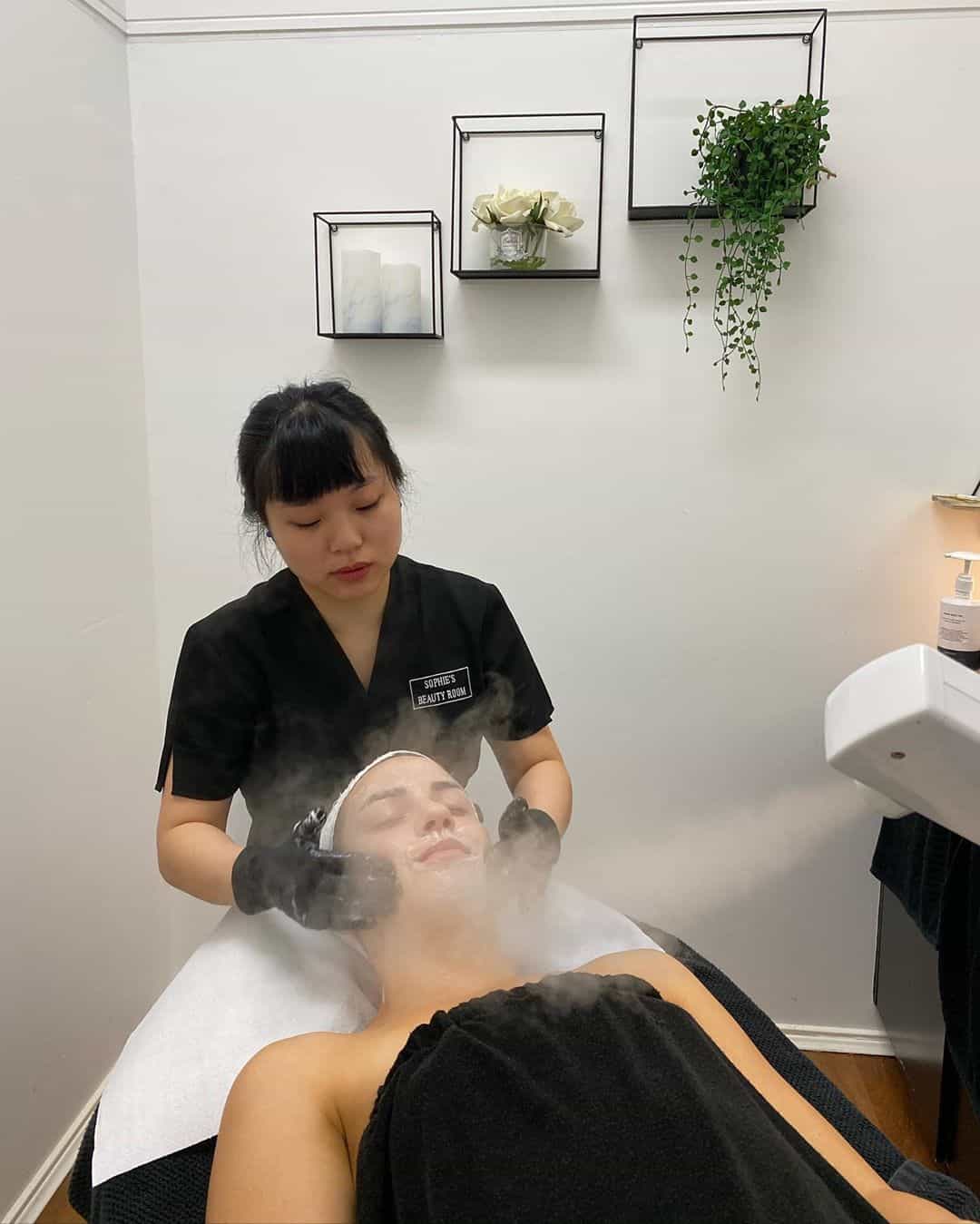 Joanna steaming a client's skin during a facial at Sophie's Beauty Room